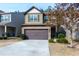 Two-story house with brown garage door and landscaped yard at 4505 Ravenwood Dr, Union City, GA 30291
