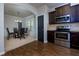 Modern kitchen with stainless steel appliances and dark wood cabinets at 4505 Ravenwood Dr, Union City, GA 30291