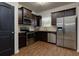 Kitchen with stainless steel appliances and dark cabinets at 4505 Ravenwood Dr, Union City, GA 30291
