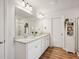 Double vanity bathroom with granite countertop and large mirror at 824 Lakehaven Ln, Loganville, GA 30052