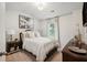 Charming bedroom featuring a full bed, window, and dark wood furniture at 824 Lakehaven Ln, Loganville, GA 30052