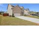 Side view of a two-story house with a long driveway at 824 Lakehaven Ln, Loganville, GA 30052