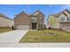 Brick two-story house with a gray door and attached garage at 824 Lakehaven Ln, Loganville, GA 30052