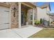 House entrance with brick columns and a gray door at 824 Lakehaven Ln, Loganville, GA 30052