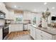 Open concept kitchen with white cabinets, stainless steel appliances, and island at 824 Lakehaven Ln, Loganville, GA 30052