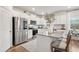 Modern kitchen with white cabinets, stainless steel appliances and island at 824 Lakehaven Ln, Loganville, GA 30052