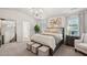 Spacious main bedroom with large bed, seating area, and mirror at 824 Lakehaven Ln, Loganville, GA 30052