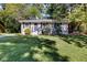 Ranch style home with a well-manicured lawn and mature trees at 1003 Springdale Dr, Marietta, GA 30062