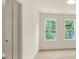 Bright bedroom featuring two large windows and carpet flooring at 704 Fairgate Rd, Marietta, GA 30064