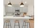 Kitchen island with white countertops and three barstools at 704 Fairgate Rd, Marietta, GA 30064