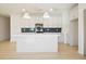 Modern kitchen with white cabinets, an island, and blue tile backsplash at 704 Fairgate Rd, Marietta, GA 30064