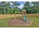play area with a swing set and slide at 704 Fairgate Rd, Marietta, GA 30064