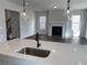 Modern kitchen island with sink, faucet, and white quartz countertop at 4048 Annsbury Ct, Lilburn, GA 30047