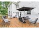 Deck with patio furniture and umbrella, overlooking backyard at 2080 Misty Oaks Dr, Buford, GA 30519