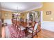 Formal dining room with large table and hardwood floors at 2080 Misty Oaks Dr, Buford, GA 30519