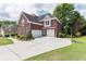 Brick home with three-car garage and basketball court at 2080 Misty Oaks Dr, Buford, GA 30519