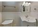 A bright bathroom with white cabinets, white paneled wainscoting, and updated fixtures at 3337 Devaughn Ne Dr, Marietta, GA 30066