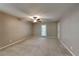 Large bonus room with plush carpeting, neutral paint, a ceiling fan, and outdoor access at 3337 Devaughn Ne Dr, Marietta, GA 30066