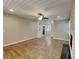 Open concept living space featuring wood floors, a stone fireplace, and a ceiling fan at 3337 Devaughn Ne Dr, Marietta, GA 30066