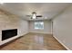 Bright living room with hardwood floors, stone fireplace, ceiling fan, and natural light from a window at 3337 Devaughn Ne Dr, Marietta, GA 30066