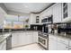 White kitchen with granite countertops and stainless steel appliances at 36 Chaumont Square Northwest Nw Sq, Atlanta, GA 30327