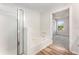 Bright bathroom featuring a walk-in shower, large tub, and modern wood-look flooring at 5845 Hampton Ct, Atlanta, GA 30349