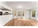 Bright dining area features hardwood floors, large windows, and an open layout to the kitchen at 5845 Hampton Ct, Atlanta, GA 30349