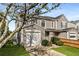 View of townhome showcasing well-maintained landscaping, tidy lawn and garage at 5845 Hampton Ct, Atlanta, GA 30349