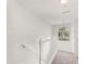 Hallway with white railings with a view of a window with natural lighting at 5845 Hampton Ct, Atlanta, GA 30349