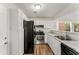 Well-lit kitchen featuring white cabinets, granite countertops, and stainless steel appliances at 5845 Hampton Ct, Atlanta, GA 30349