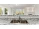 Open kitchen design overlooking a living room with white marble fireplace and a large bright bay window at 5845 Hampton Ct, Atlanta, GA 30349