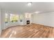 Living room boasts wood floors, a fireplace, large windows offering natural light and space at 5845 Hampton Ct, Atlanta, GA 30349