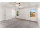 Spacious main bedroom featuring a tray ceiling, ceiling fan, and large windows at 5845 Hampton Ct, Atlanta, GA 30349