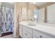 Clean bathroom with white vanity, large mirror, and shower at 169 Blue Creek Ln, Loganville, GA 30052