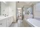 Primary bathroom with a soaking tub, walk-in shower, and double vanity at 169 Blue Creek Ln, Loganville, GA 30052