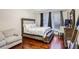 Spacious bedroom with hardwood floors, a king-size bed, and sitting area at 169 Blue Creek Ln, Loganville, GA 30052