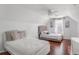 Bright bedroom with two beds, hardwood floors, and a ceiling fan at 169 Blue Creek Ln, Loganville, GA 30052