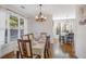 Charming dining room with hardwood floors, a chandelier, and adjacent kitchen access at 169 Blue Creek Ln, Loganville, GA 30052