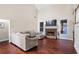 Spacious Gathering room boasts hardwood floors, a stone fireplace, and large sectional sofa at 169 Blue Creek Ln, Loganville, GA 30052