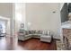Open concept Gathering room with hardwood floors, a stone fireplace, and a large sectional sofa at 169 Blue Creek Ln, Loganville, GA 30052