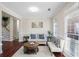 Bright living room featuring hardwood floors, a comfy sofa, and large windows at 169 Blue Creek Ln, Loganville, GA 30052