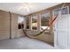 Relaxing sunroom with a hammock and multiple windows at 169 Blue Creek Ln, Loganville, GA 30052