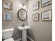 Elegant powder room with pedestal sink and framed art at 213 Bastian Dr # 6, Villa Rica, GA 30180