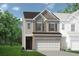 Two-story townhome with brick and siding exterior, two-car garage, and landscaping at 213 Bastian Dr # 6, Villa Rica, GA 30180