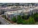 Aerial view of a large apartment complex with rooftop parking and tree-lined streets at 390 17Th Nw St # 4063, Atlanta, GA 30363