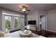 Living room with dark wood floors, large windows, modern decor, and a view to the bedroom at 390 17Th Nw St # 4063, Atlanta, GA 30363