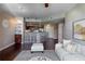 View of open floor plan featuring a breakfast bar with seating and floating glass shelves at 390 17Th Nw St # 4063, Atlanta, GA 30363