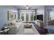 Bright living room featuring a plush white sofa, modern decor, and large windows at 390 17Th Nw St # 4063, Atlanta, GA 30363