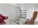 Open office area with sleek glass desk, stylish chair, and shelving for an organized workspace at 390 17Th Nw St # 4063, Atlanta, GA 30363