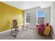 Bright office space with a large glass desk, red chair, and great natural light from the two windows at 390 17Th Nw St # 4063, Atlanta, GA 30363